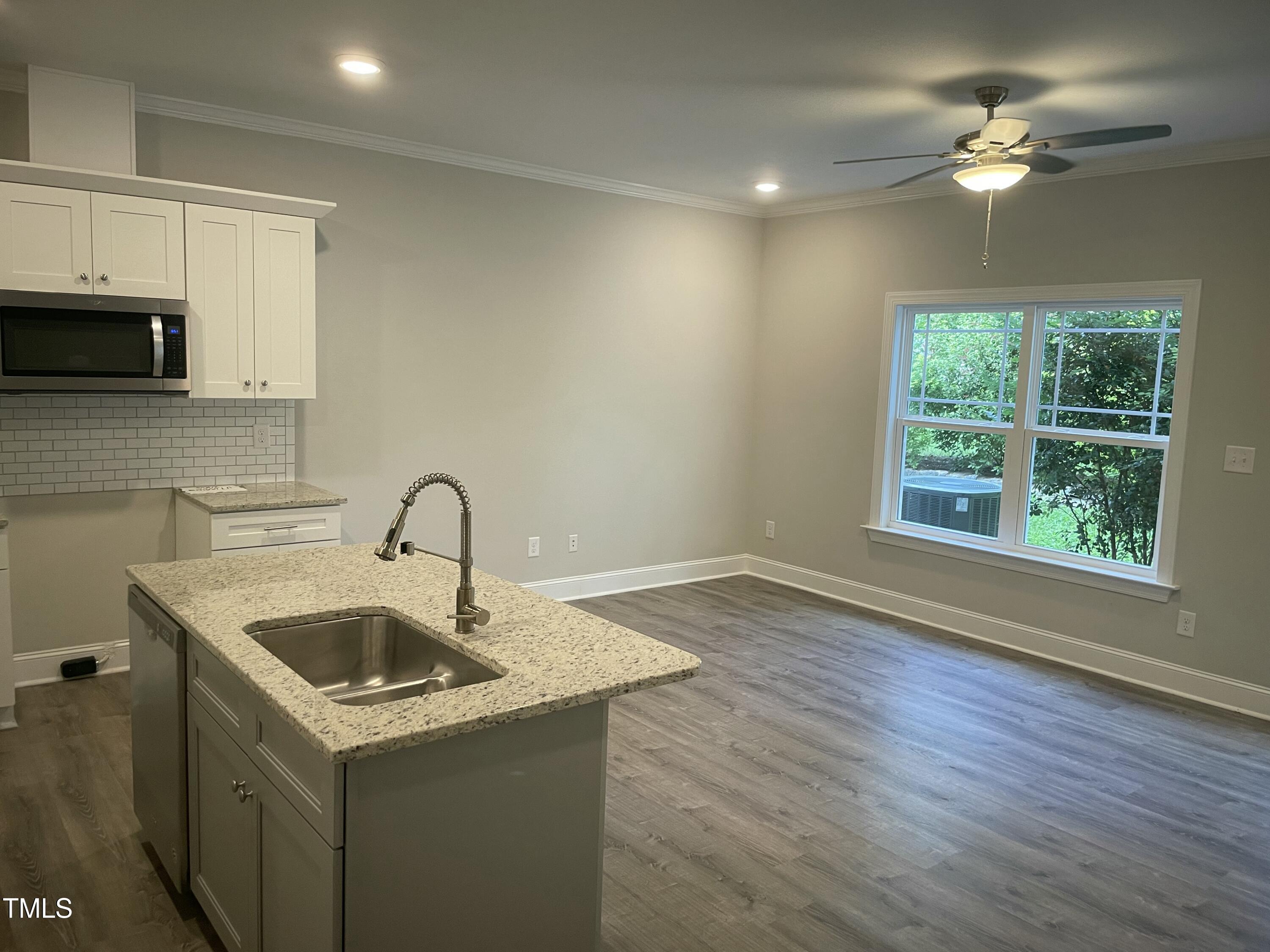 5502 Batoul Lane Raleigh, NC 27606 - Photo 6 of 35 a kitchen that has a sink and a stove