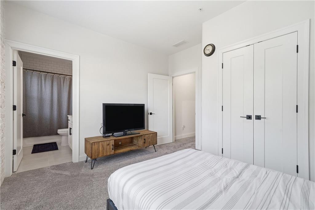320 Concord Street Alpharetta, GA 30009 - Photo 26 of 48 a bedroom with bed and flat tv screen tv
