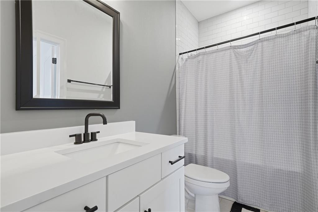 320 Concord Street Alpharetta, GA 30009 - Photo 28 of 48 a bathroom with a sink a toilet and shower curtain