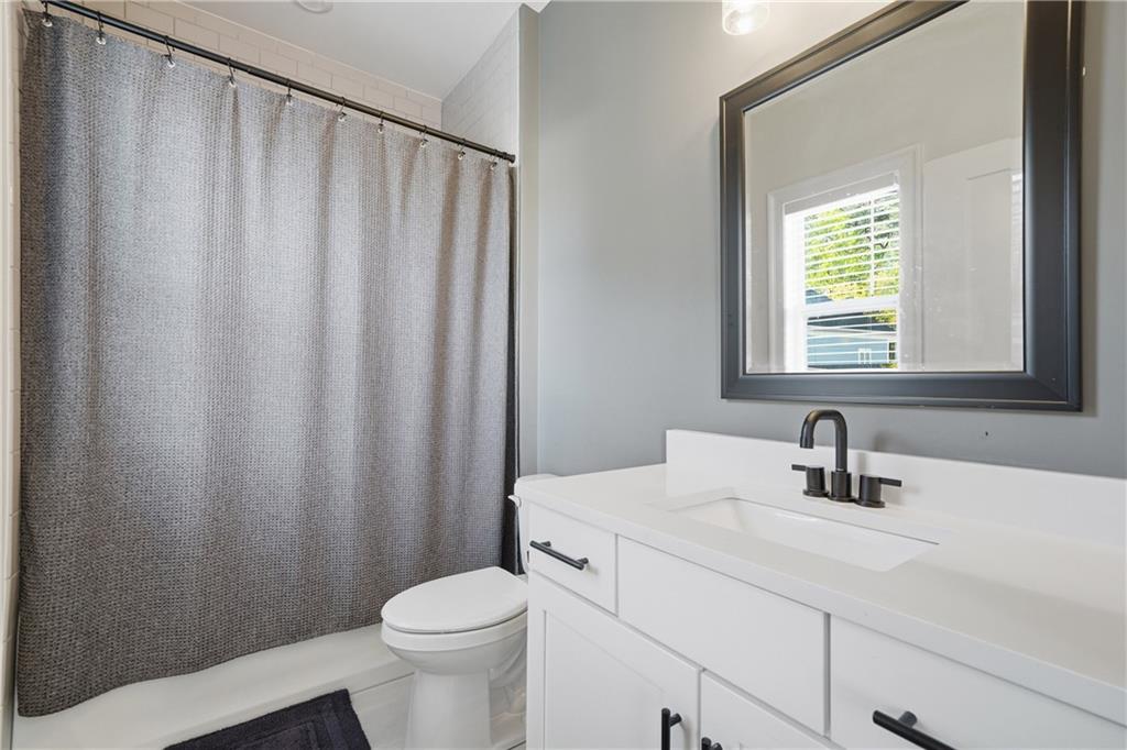 320 Concord Street Alpharetta, GA 30009 - Photo 29 of 48 a bathroom with a sink a toilet and shower curtain