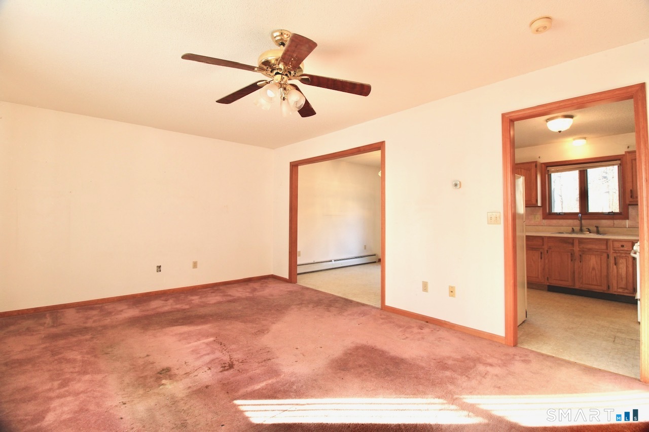 6 North Lane Wallingford, CT 06492 - Photo 14 of 34 a view of a livingroom with a ceiling fan and a window
