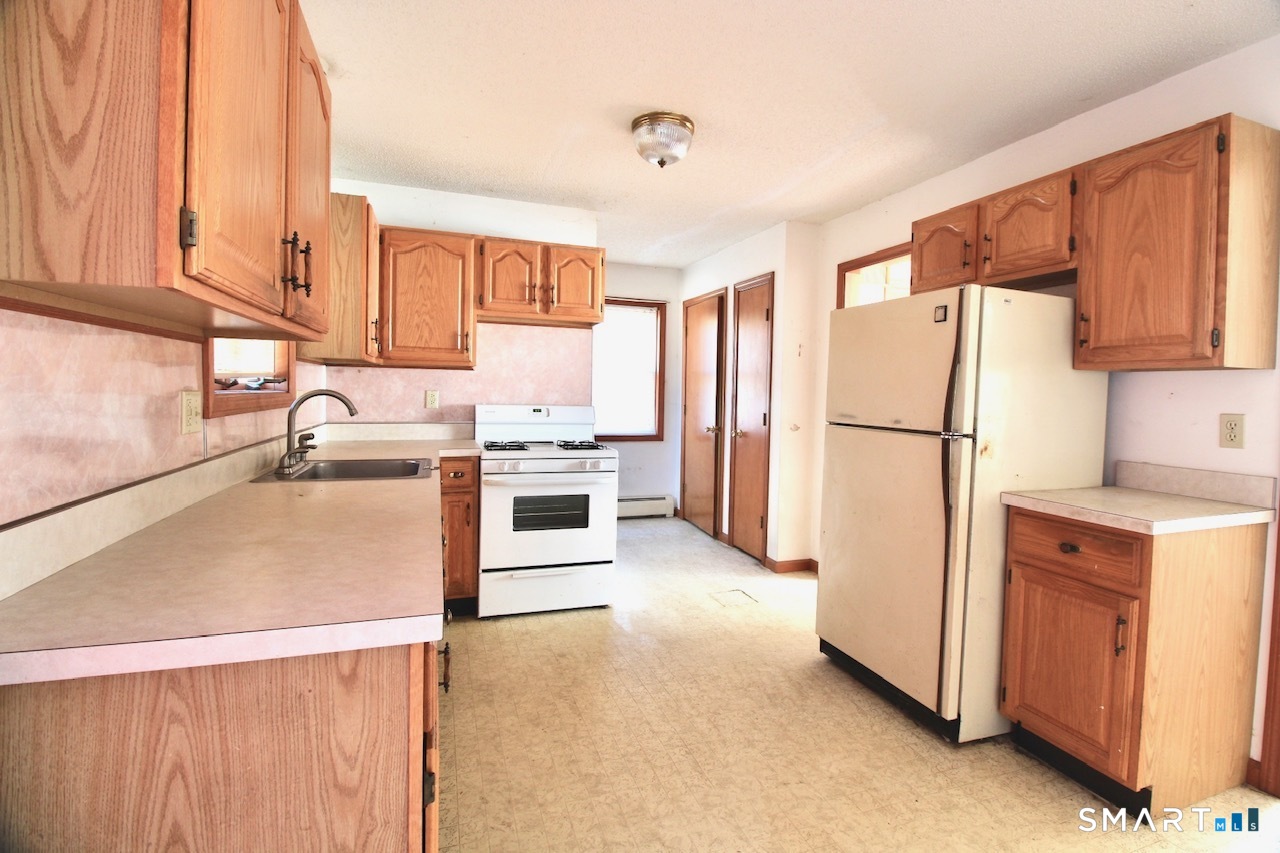 6 North Lane Wallingford, CT 06492 - Photo 15 of 34 a kitchen with stainless steel appliances a refrigerator sink and cabinets