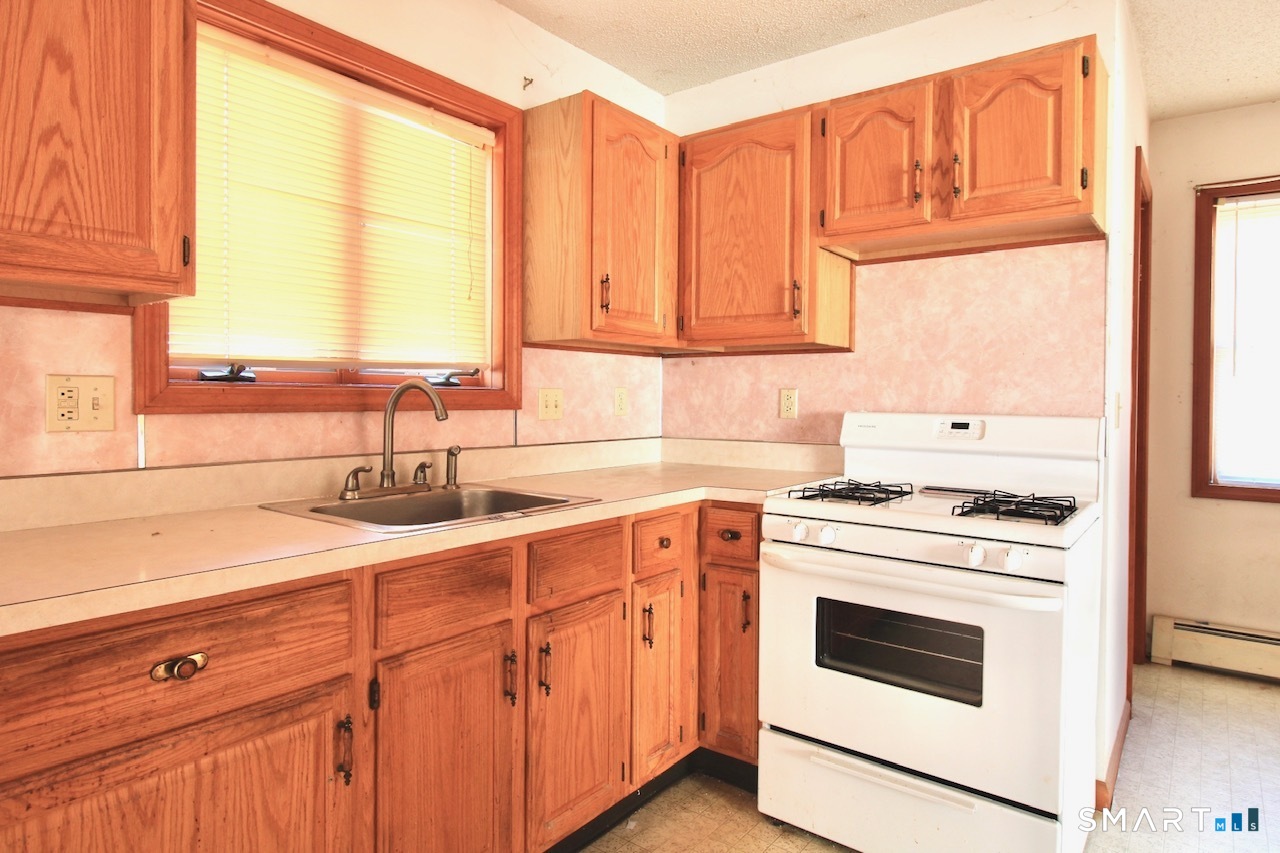 6 North Lane Wallingford, CT 06492 - Photo 16 of 34 a kitchen with granite countertop white cabinets and white appliances