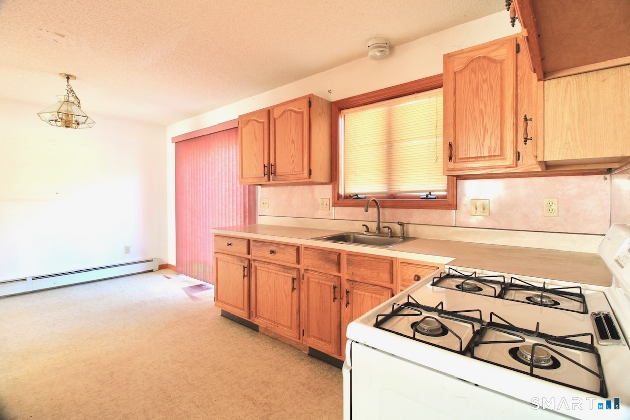 6 North Lane Wallingford, CT 06492 - Photo 17 of 34 a kitchen with stainless steel appliances granite countertop a sink stove and a refrigerator