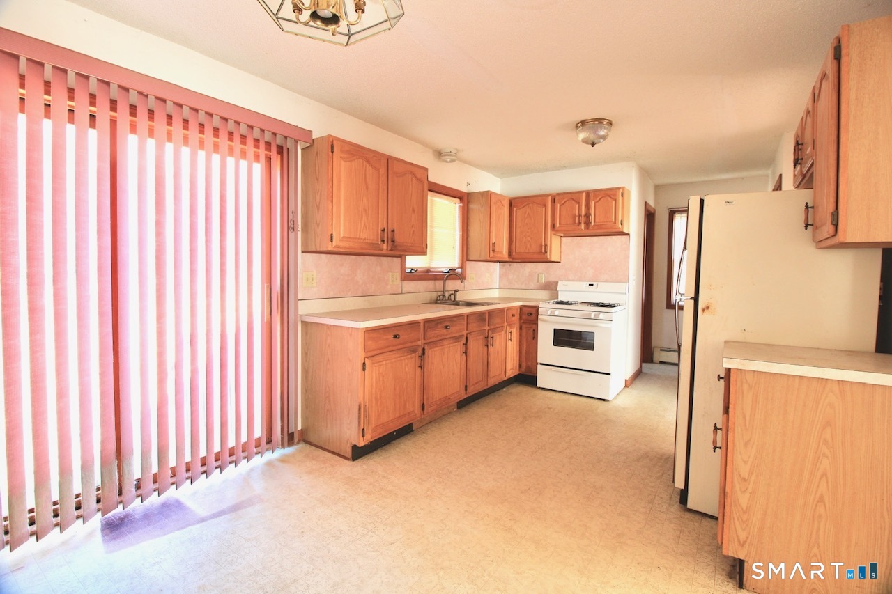 6 North Lane Wallingford, CT 06492 - Photo 18 of 34 a kitchen with a refrigerator a stove top oven and white walls