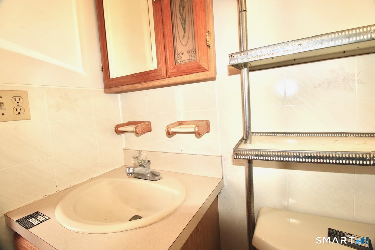 6 North Lane Wallingford, CT 06492 - Photo 20 of 34 a bathroom with a sink and a mirror