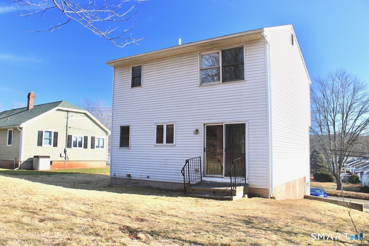 6 North Lane Wallingford, CT 06492 - Photo 4 of 34 a front view of a house with a yard