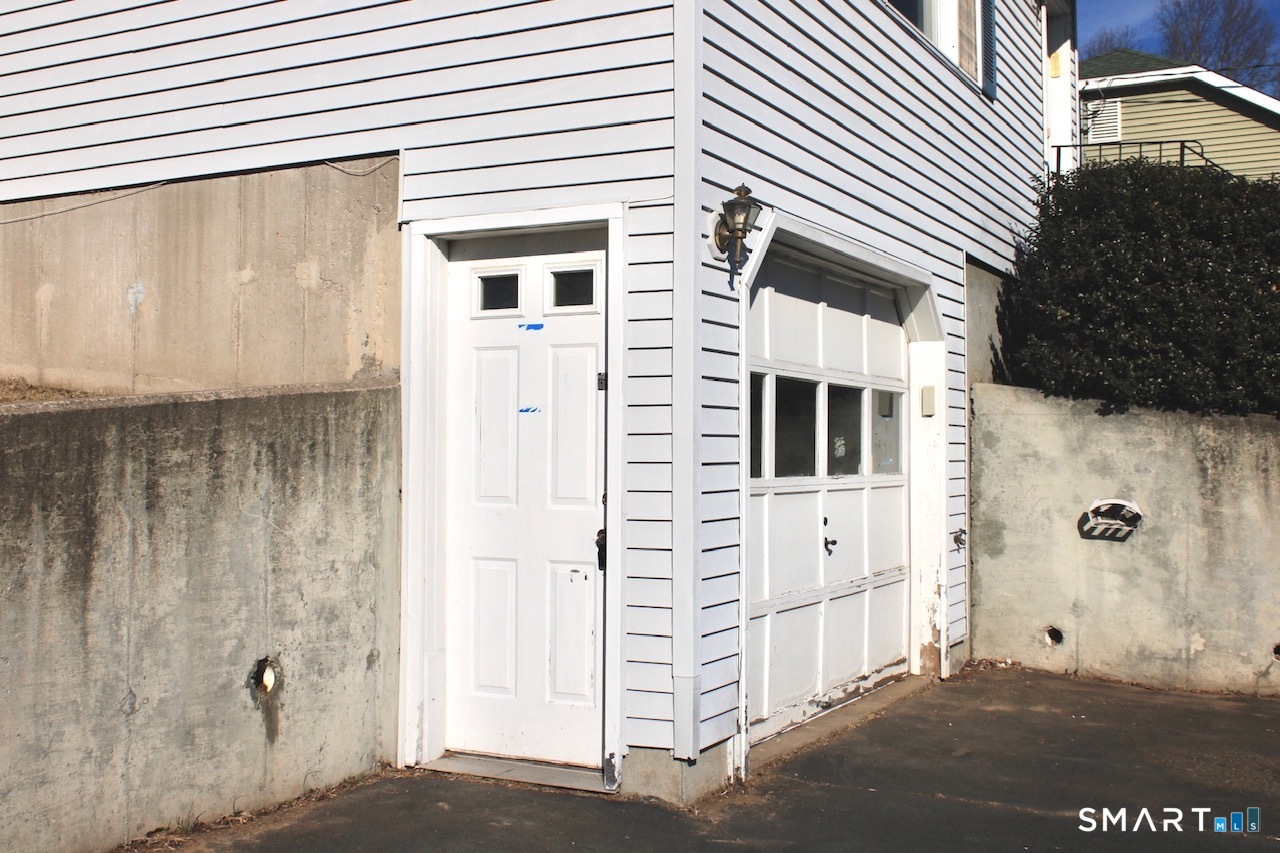 6 North Lane Wallingford, CT 06492 - Photo 7 of 34 a view of a house with a door and wooden bench