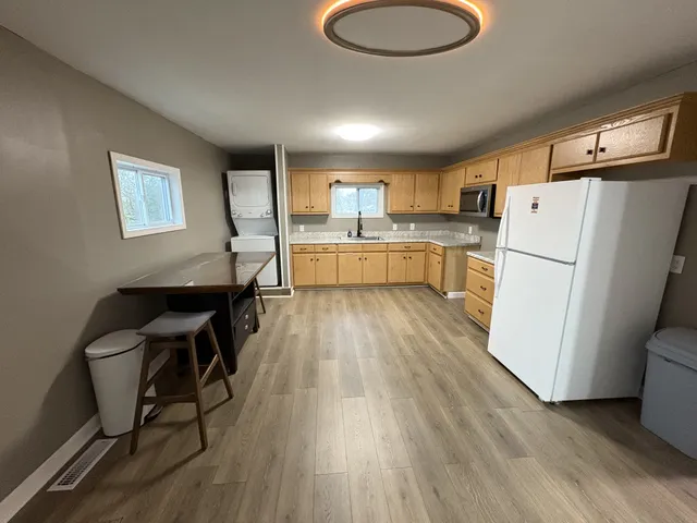 a kitchen with a refrigerator a sink and a stove top oven