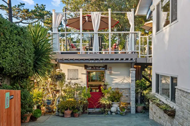 a view of an outdoor space with furniture and umbrella