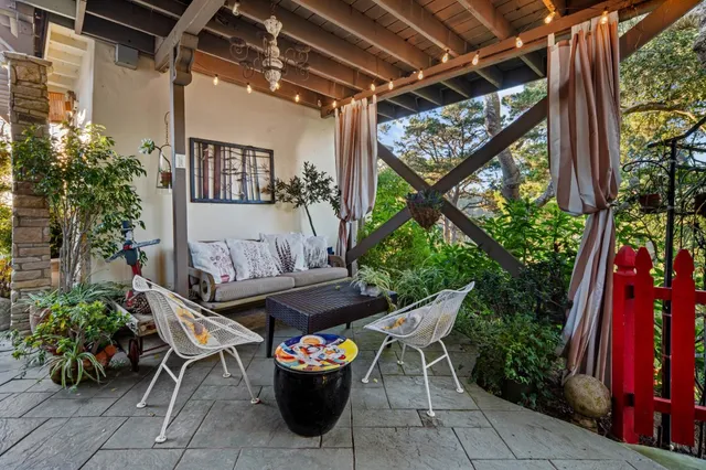 an aerial view of a house with a yard and outdoor seating