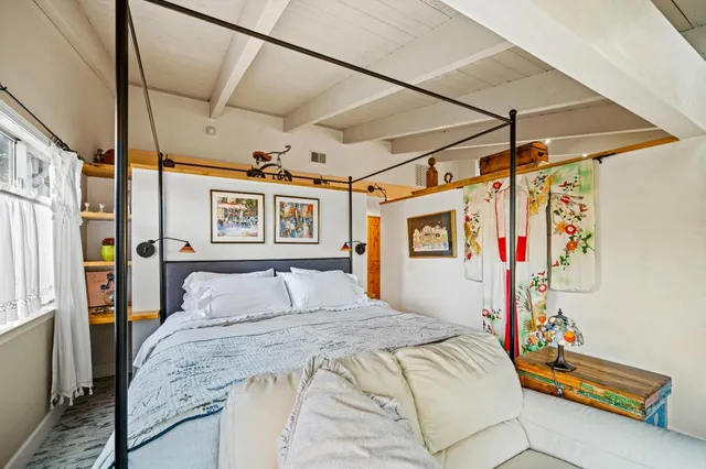a living room with furniture a flat screen tv and floor to ceiling window