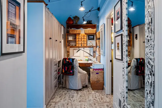 a living room with furniture a flat screen tv and a floor to ceiling window