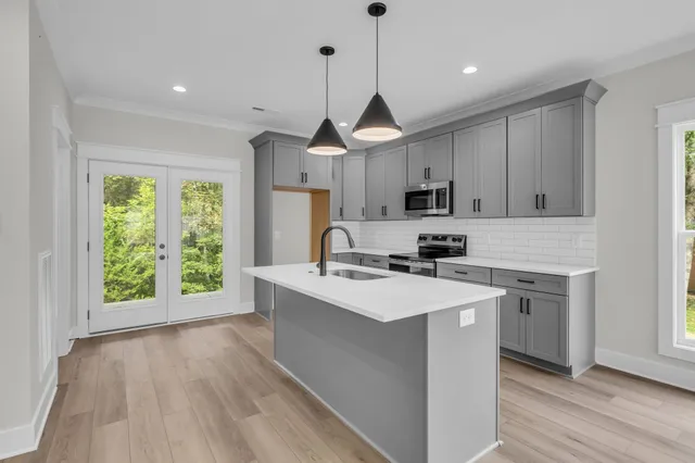 a kitchen with a sink a stove a microwave and cabinets