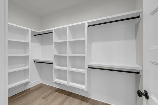 a view of walk in closet with empty racks