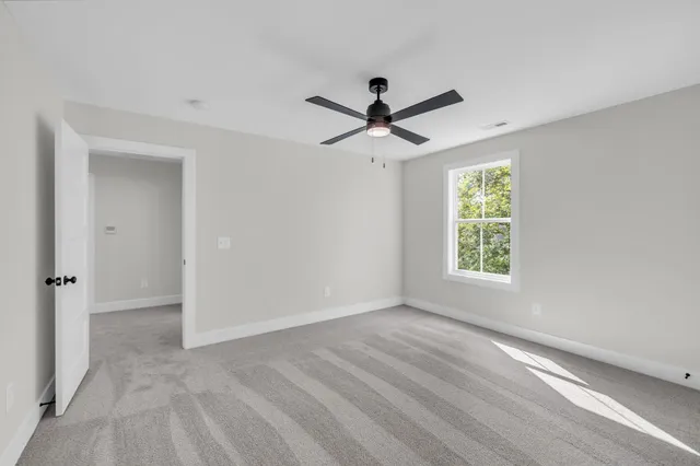 a view of a livingroom with a ceiling fan and window