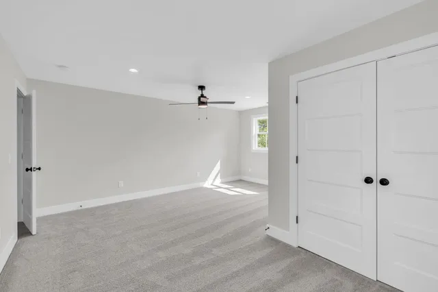 an empty room with wooden floor and cabinet