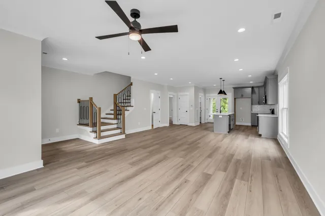 a view of empty room with wooden floor and window