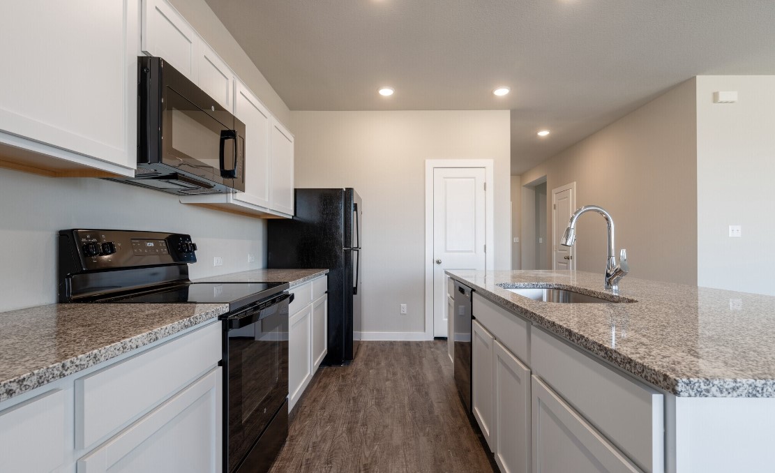 20107 Park Strip Street, Unit A Lago Vista, TX 78645 - Photo 10 of 15 a kitchen with stainless steel appliances granite countertop a sink stove and refrigerator
