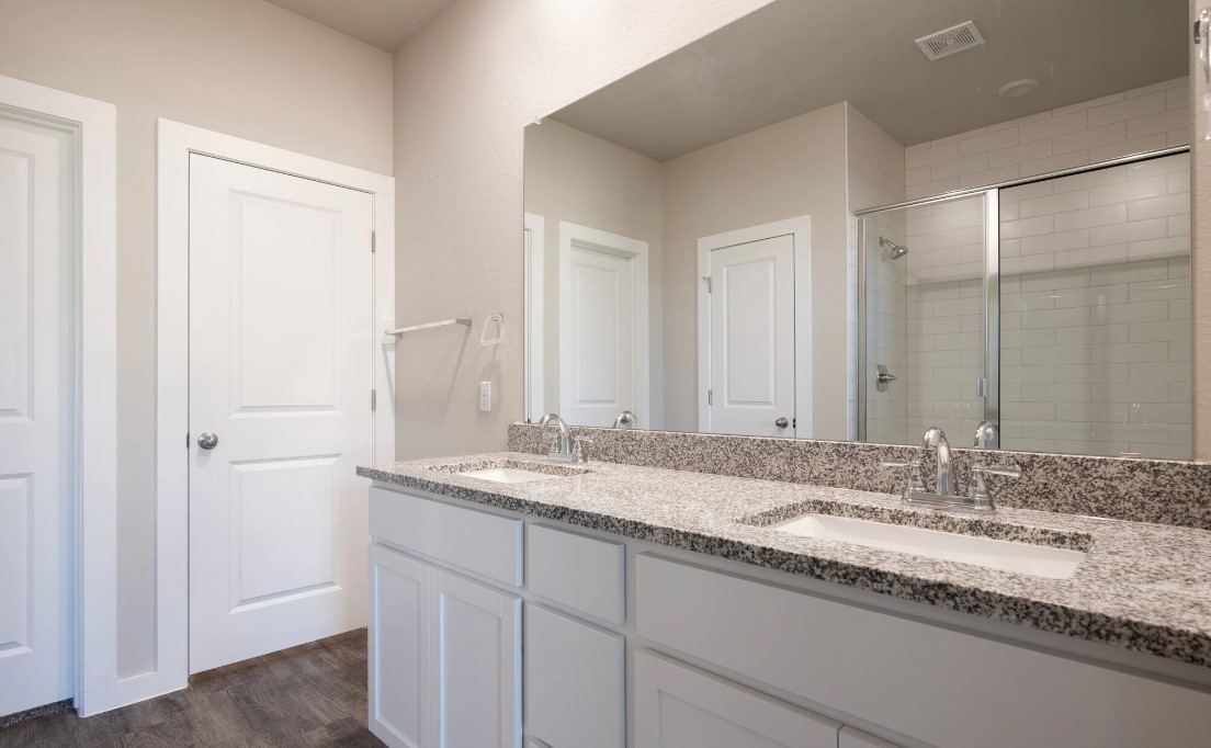 20107 Park Strip Street, Unit A Lago Vista, TX 78645 - Photo 12 of 15 a bathroom with a granite countertop sink and a mirror