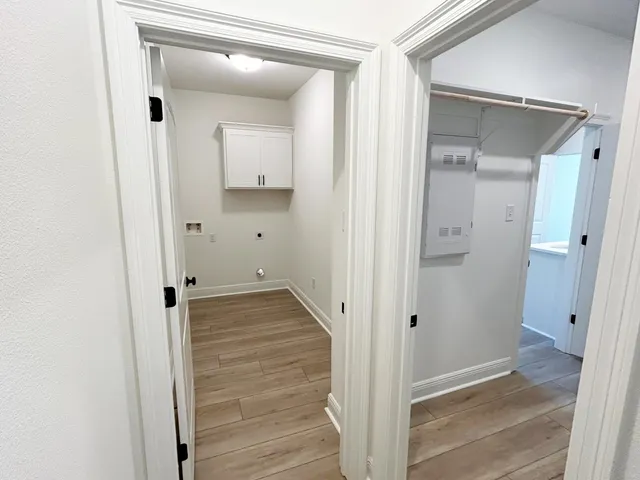 a view of a hallway with wooden floor and entryway