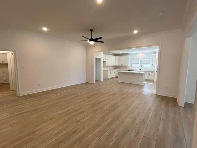 a view of a kitchen with a sink and wooden floor