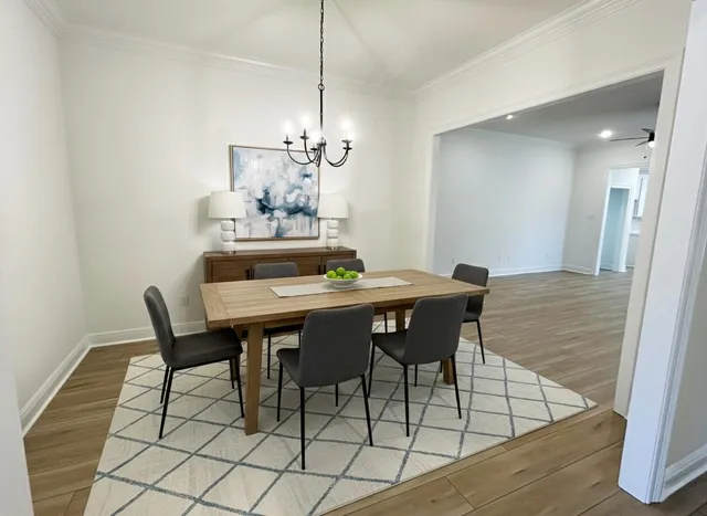 a dining room with furniture and chandelier