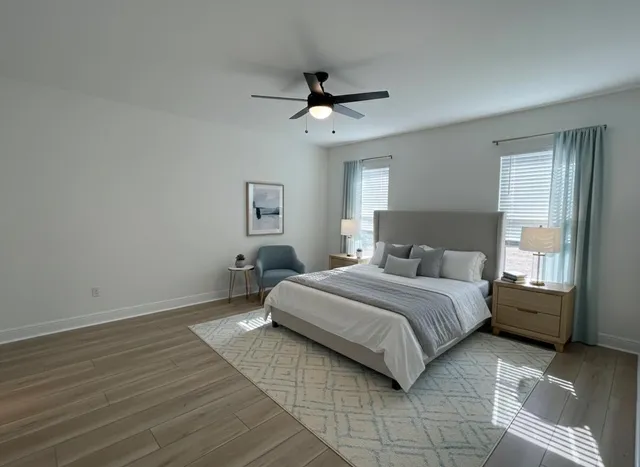 a spacious bedroom with a bed and window