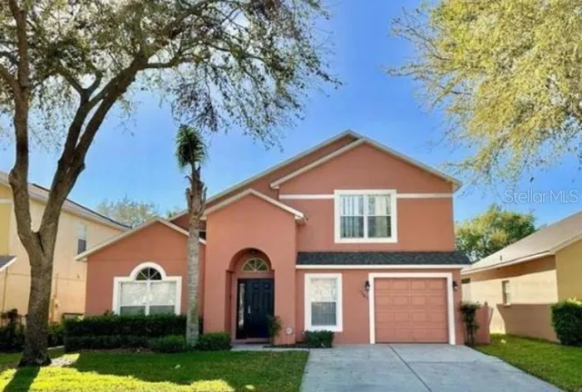 a view of a brick house with a large windows and a large tree
