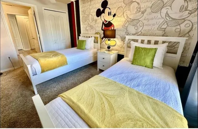 a bedroom with 2 bed and a mirror