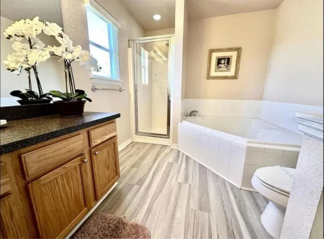 a bathroom with a sink a faucet a mirror and a shower