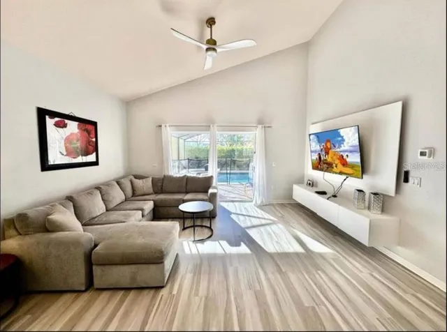 a living room with furniture and a flat screen tv