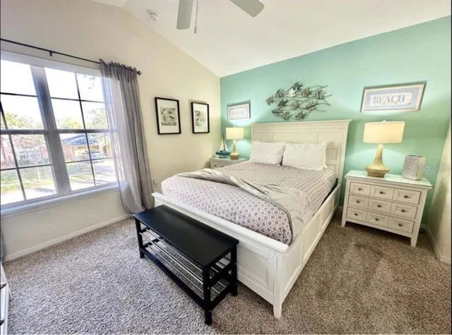 a bedroom with a bed and a window