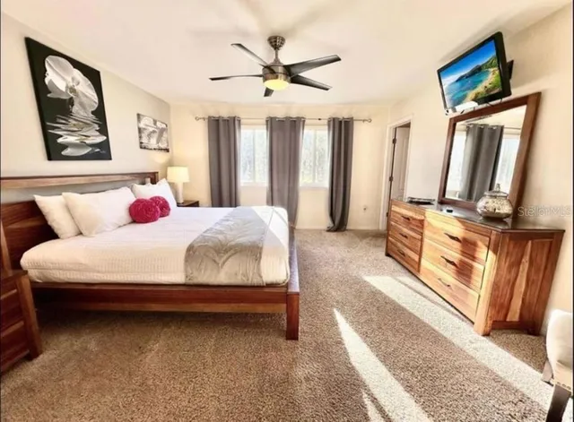 a bedroom with bed and window