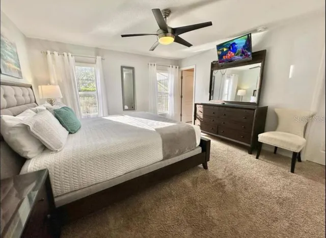 a bedroom with a bed a couch and a dresser