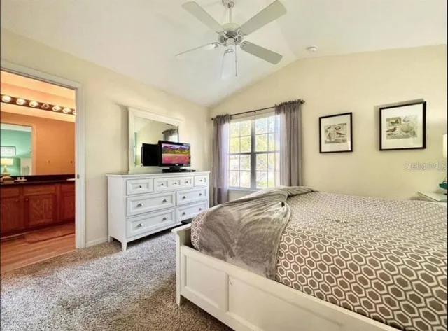 a bed room with a bed and a television