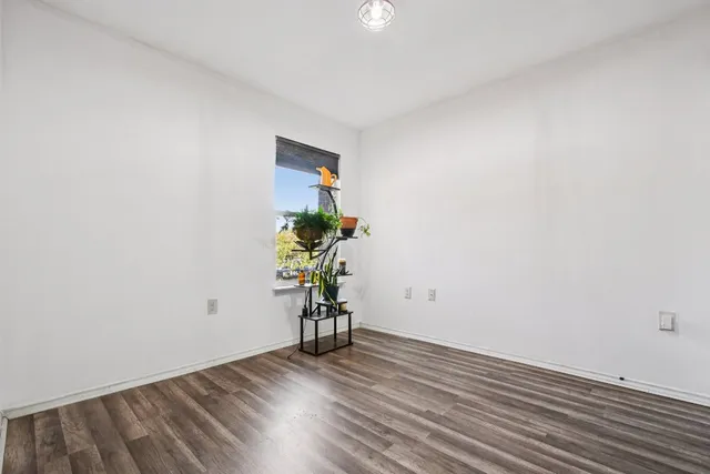 a view of an empty room and wooden floor