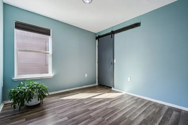 a view of an empty room and wooden floor