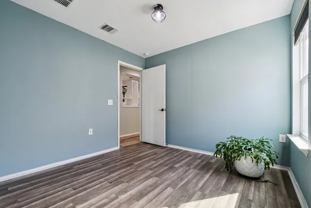 a bedroom with a bed and a potted plant
