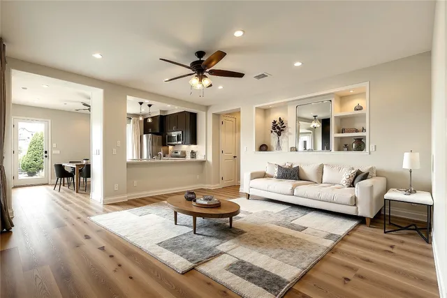a living room with furniture and a wooden floor