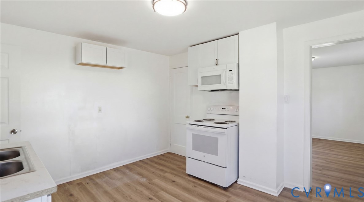 205 Cobb Street Franklin, VA 23851 - Photo 11 of 57 a room with white cabinets and wooden floor
