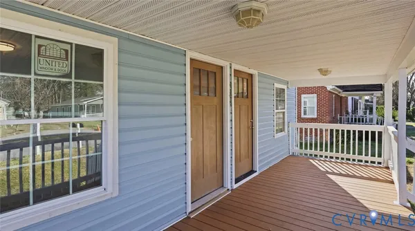 a view of a deck with chairs and wooden fence