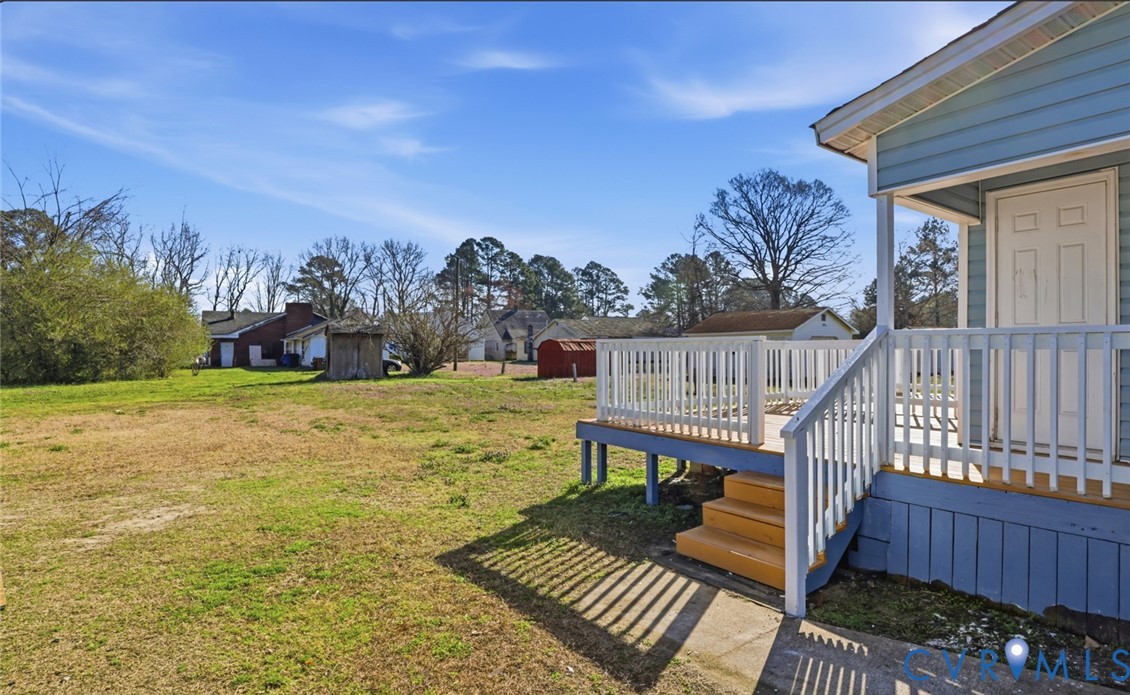 205 Cobb Street Franklin, VA 23851 - Photo 14 of 57 a view of a deck with chairs and wooden fence