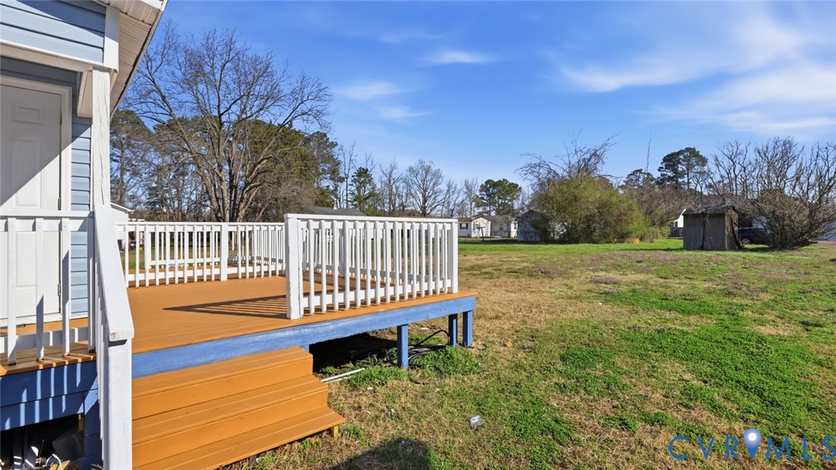 205 Cobb Street Franklin, VA 23851 - Photo 15 of 57 View of grassy yard featuring a deck