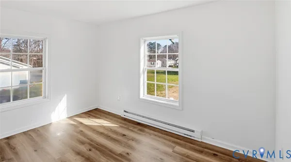 a view of an empty room with wooden floor