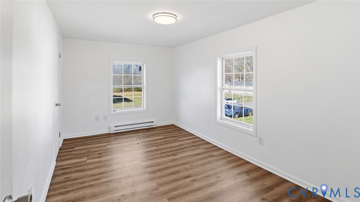 205 Cobb Street Franklin, VA 23851 - Photo 31 of 57 an empty room with wooden floor and windows
