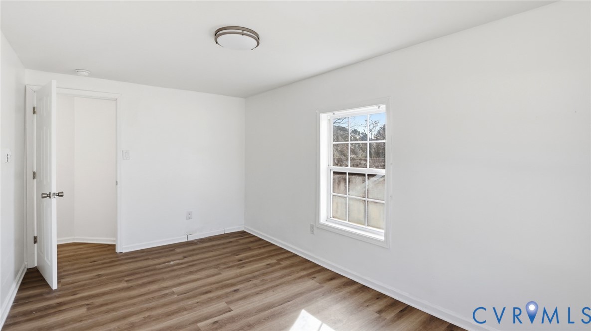 205 Cobb Street Franklin, VA 23851 - Photo 32 of 57 a view of empty room with wooden floor and fan