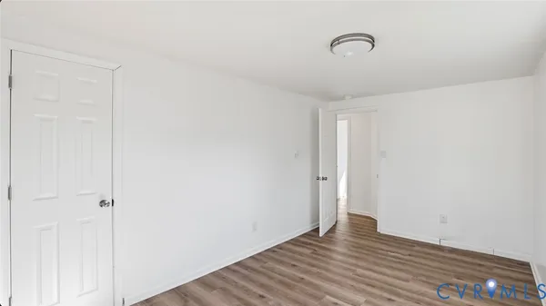 a kitchen with white cabinets sink and stove