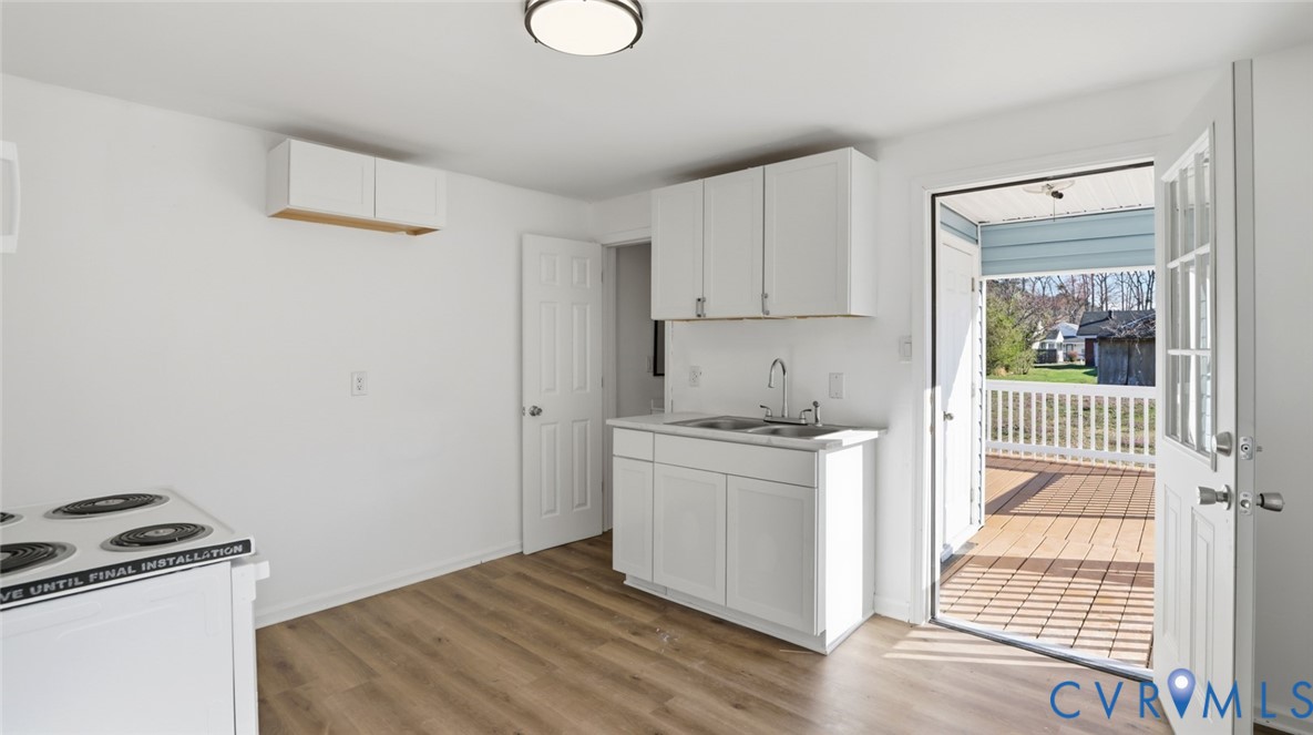 205 Cobb Street Franklin, VA 23851 - Photo 39 of 57 a kitchen with a stove and white cabinets