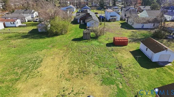 a yellow building with trees in front of it